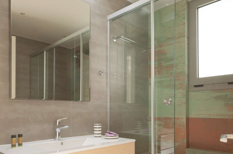 The bathroom features a walk in shower.